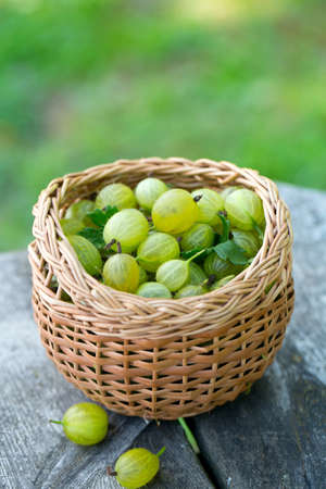 gooseberry in a basket on wooden backgroundの写真素材