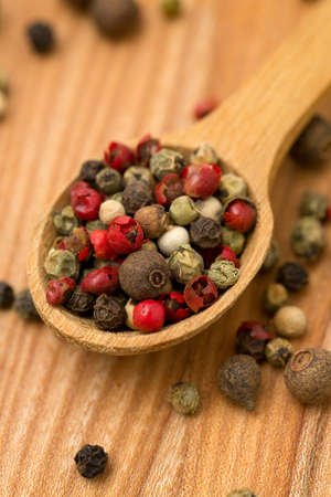 Peppercorn mix in a wooden spoon