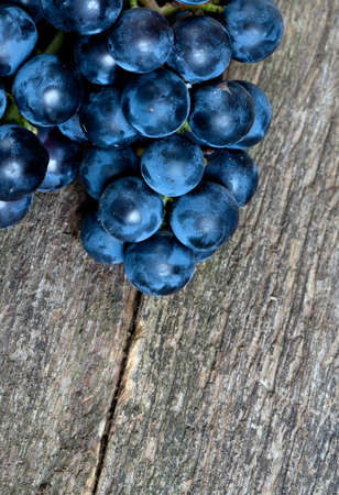 blue grapes on wooden surfaceの写真素材