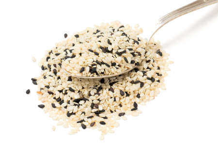 black and white sesame seeds isolated on white backgroundの写真素材