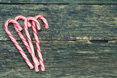 striped Christmas candies on wooden surfaceの写真素材