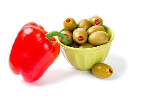 Green olives stuffed with red paprika isolated on whiteの写真素材