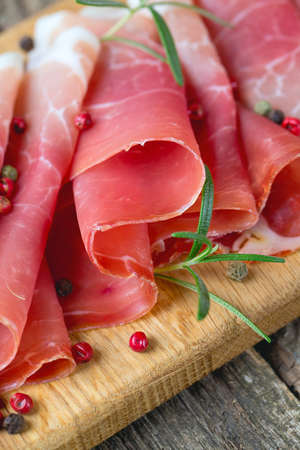 sliced prosciutto on a wooden tableの写真素材
