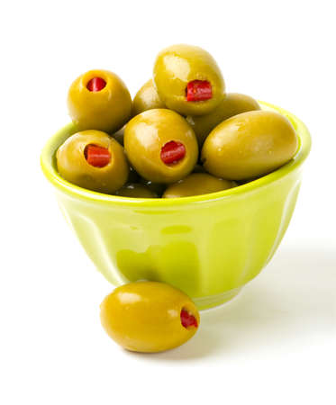 Green olives stuffed with red paprika isolated on whiteの写真素材