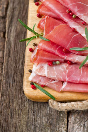 sliced prosciutto on a wooden tableの写真素材
