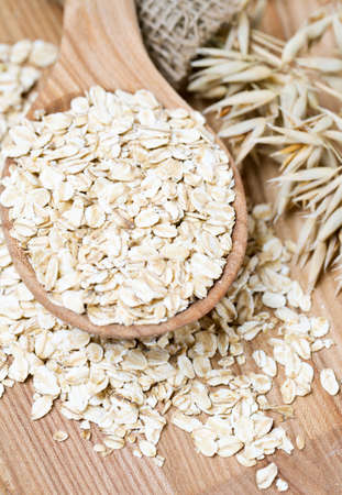 oat flakes in a spoon on wooden surface