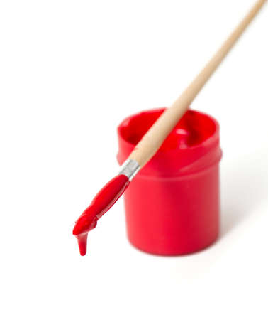 red gouache and wooden brush isolated on whiteの写真素材
