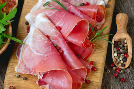 sliced prosciutto on a wooden boardの写真素材