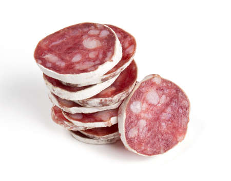 stacked sliced salami isolated on whiteの写真素材