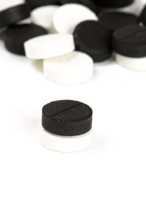black and white pills isolated on whiteの写真素材