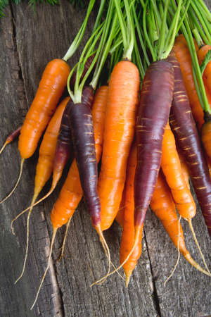 colored carrots on wooden surfaceの写真素材
