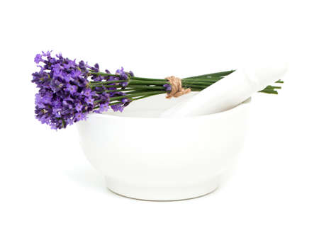 Mortar and a bouquet of lavender isolated on white の写真素材
