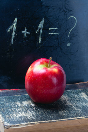 chalkboard, chalks, apple and old book