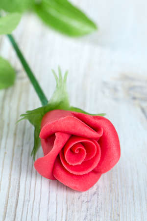 marzipan rose on wooden surfaceの写真素材