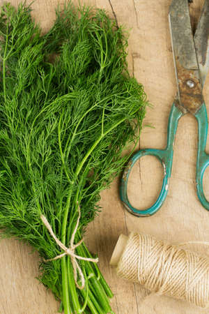 bunch of dill on wooden surfaceの写真素材