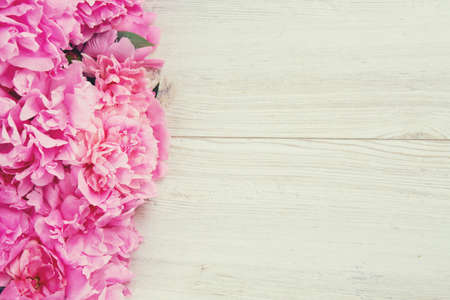 pink peonies on wooden surfaceの写真素材