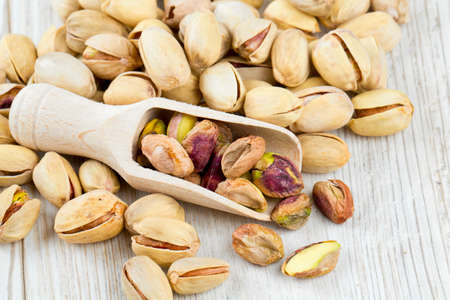 pistachios on wooden surfaceの写真素材