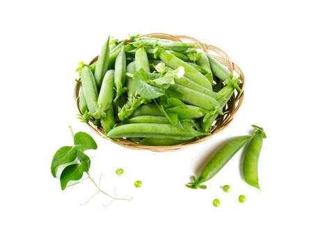 fresh pea pods in a basket isolated on whiteの写真素材