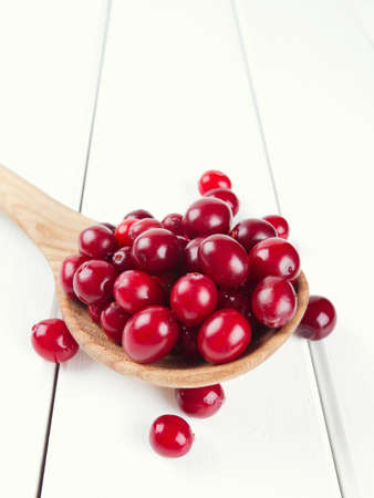 Cranberries in wooden spoon isolatedの写真素材