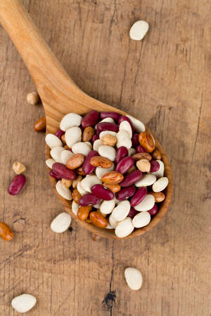 various beans on wooden surface