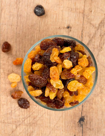 black and yellow raisings on wooden surfaceの写真素材