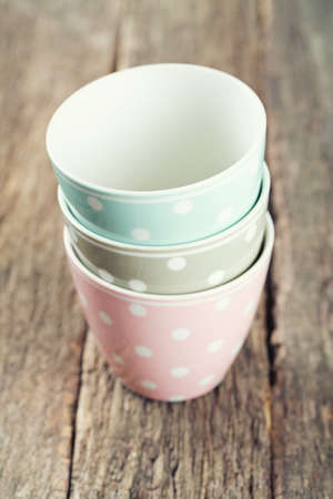 polka dot cups on wooden surfaceの写真素材