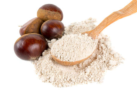 chestnut flour in a wooden spoon isolated on whiteの写真素材