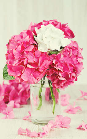 hydrangea flower in vase on wooden surfaceの写真素材