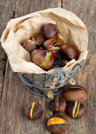 roasted chestnuts on wooden surfaceの写真素材