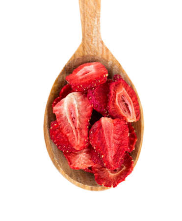 Dehydrated sliced strawberries in a wooden spoonの写真素材