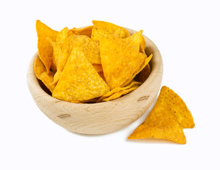 tortilla chips in a wooden bowl isolated on whiteの写真素材