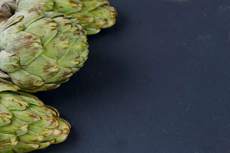 artichokes on black stone backgroundの写真素材