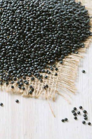 black lentils on wooden surfaceの写真素材