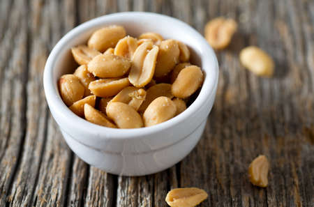 salted roasted peanuts in a bowlの写真素材