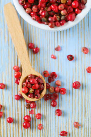 red peppercorns on wooden tableの写真素材