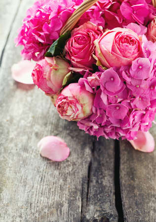 beautiful pink roses and hydrangea in basketの写真素材
