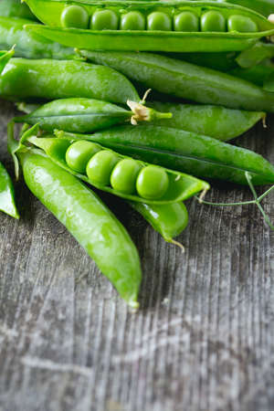 pea pods on wooden tableの写真素材