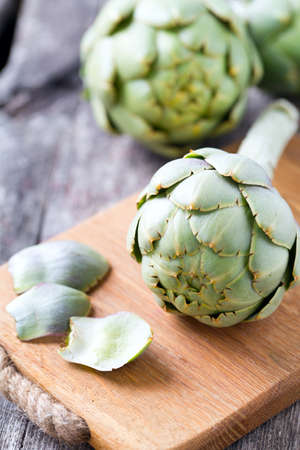 artichokes on wooden surfaceの写真素材