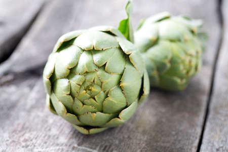 artichokes on wooden surfaceの写真素材