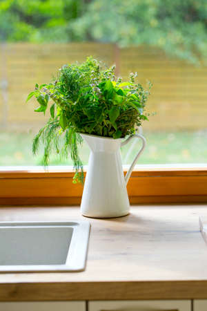 fresh herbs on kitchen tableの写真素材