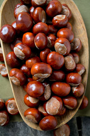 chestnuts on wooden surfaceの写真素材