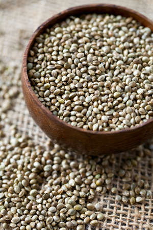 hemp seeds on wooden surfaceの写真素材