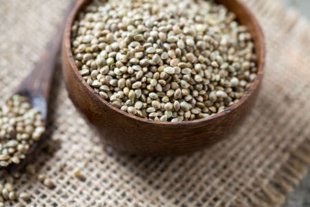 hemp seeds on wooden surfaceの写真素材