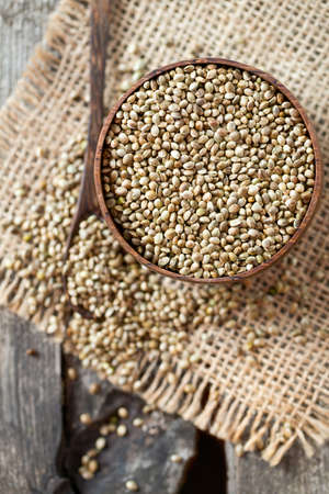 hemp seeds on wooden surfaceの写真素材