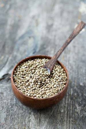 hemp seeds on wooden surfaceの写真素材