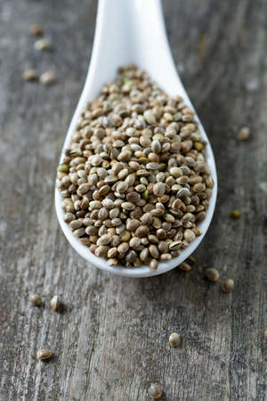 hemp seeds on wooden surfaceの写真素材