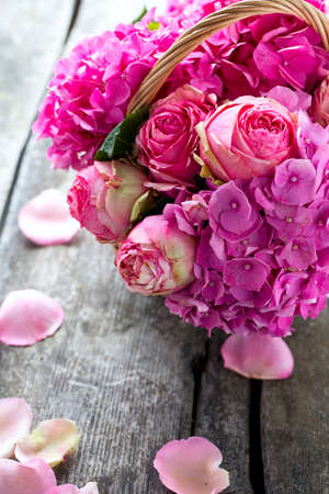 beautiful pink roses and hydrangea in basketの写真素材