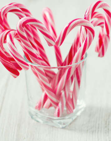 Striped Christmas candies on wooden surfaceの写真素材