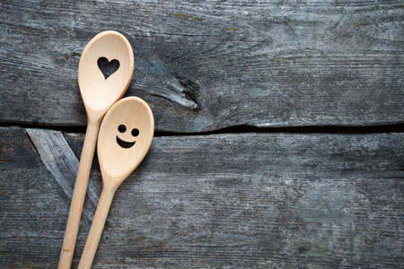 smiling wooden spoons on kitchen tableの写真素材