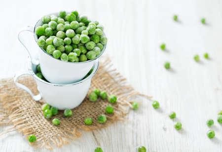 frozen peas on wooden surfaceの写真素材